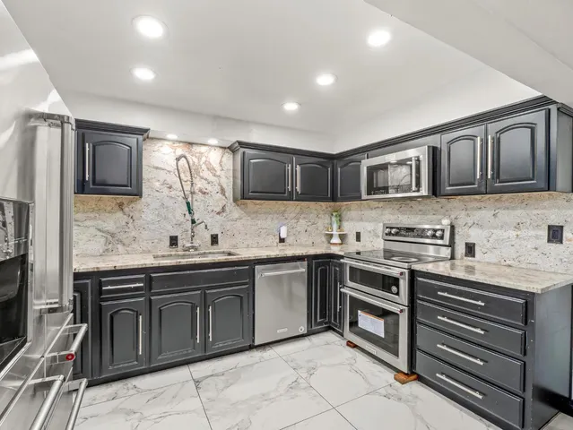a bedroom with furniture and a flat screen tv