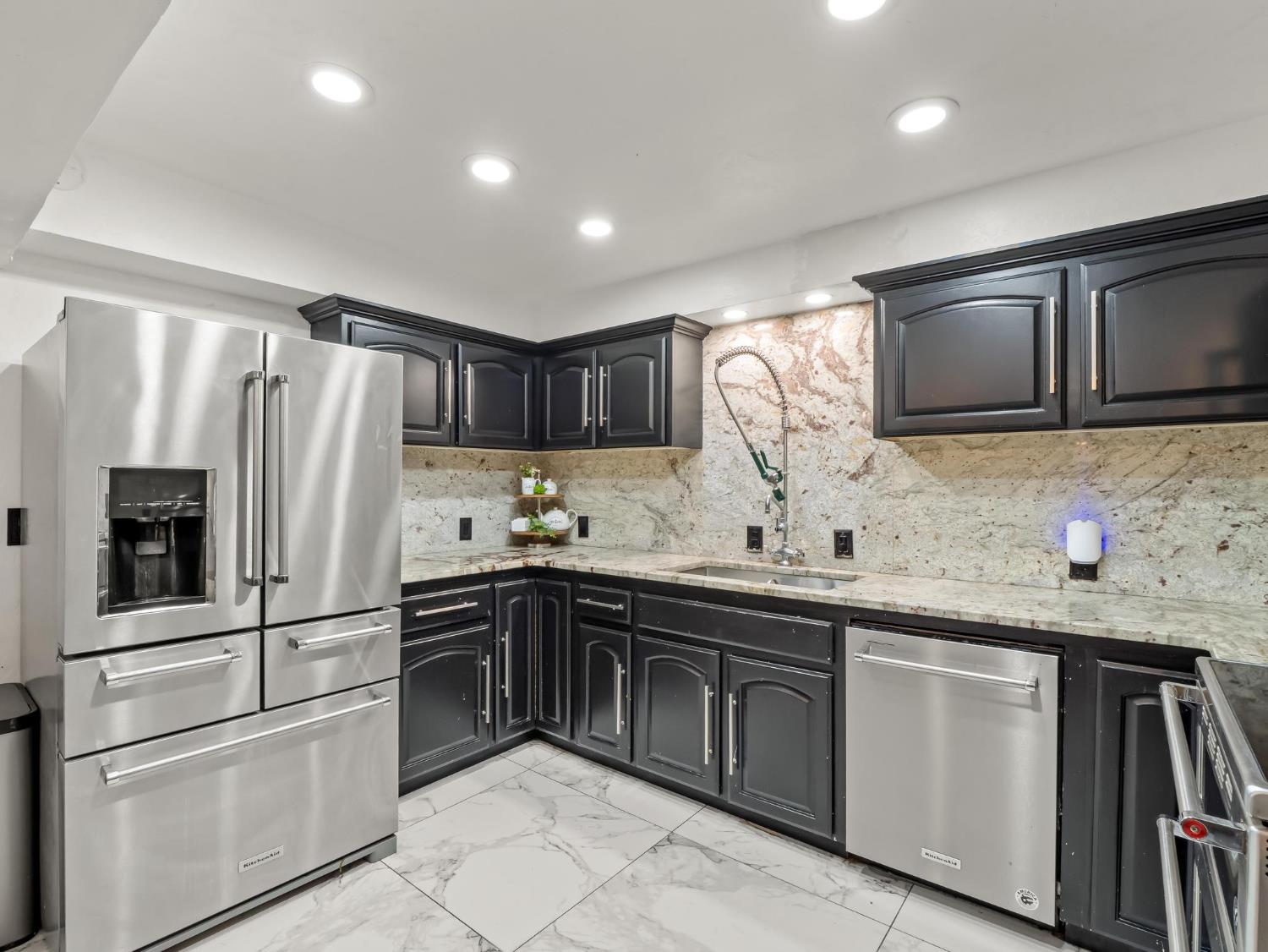 31204 Sierra Drive Exeter, CA 93221 - Photo 21 of 76 a kitchen with stainless steel appliances granite countertop a refrigerator sink and stove