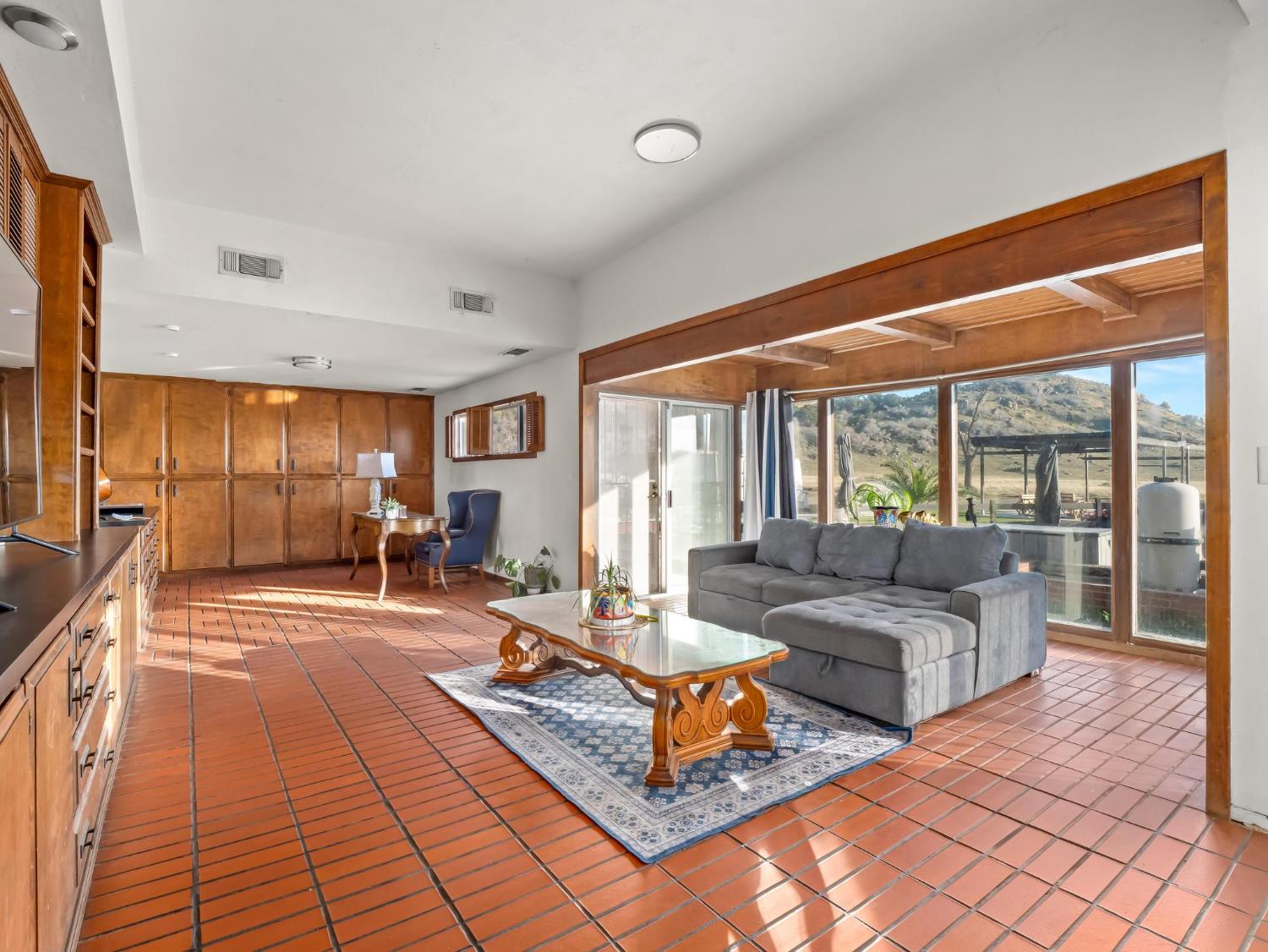 31204 Sierra Drive Exeter, CA 93221 - Photo 22 of 76 a living room with furniture and a large window