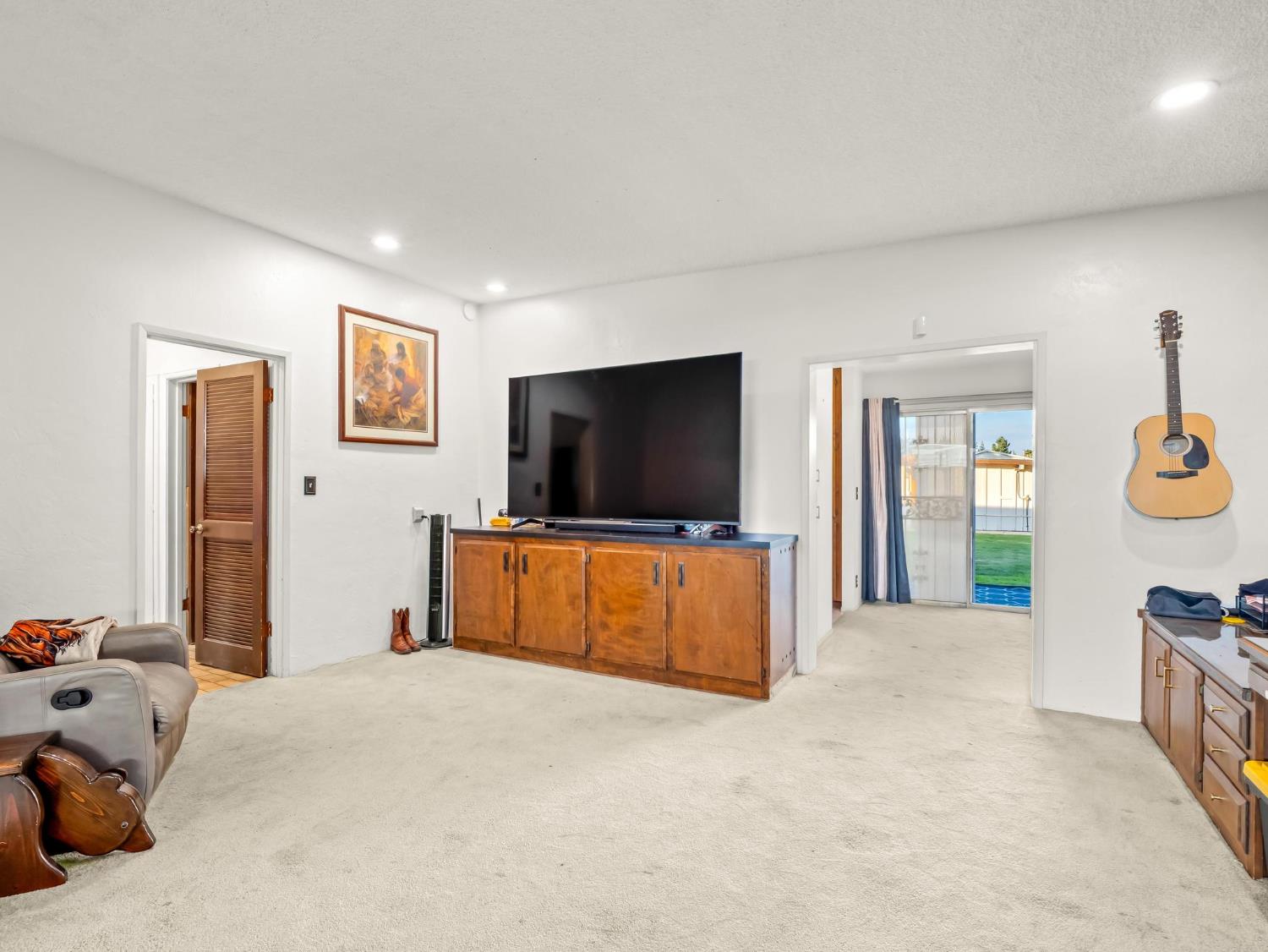 31204 Sierra Drive Exeter, CA 93221 - Photo 31 of 76 a bedroom with furniture and a flat screen tv