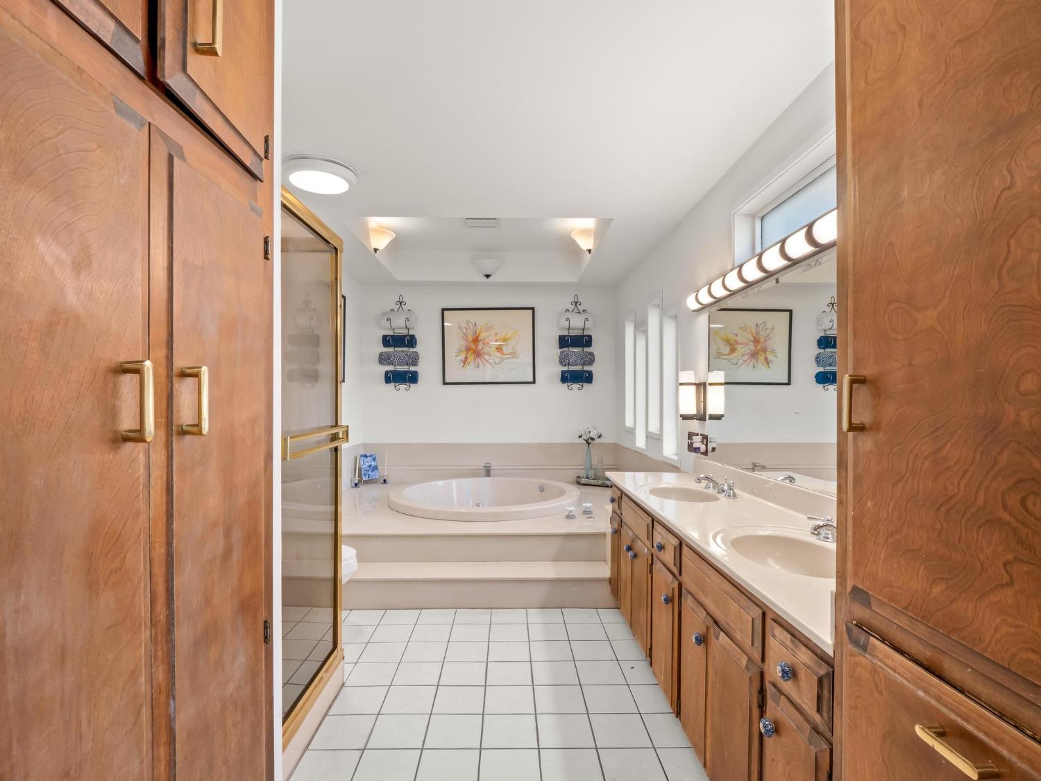 31204 Sierra Drive Exeter, CA 93221 - Photo 36 of 76 a bathroom with a tub sink and mirror