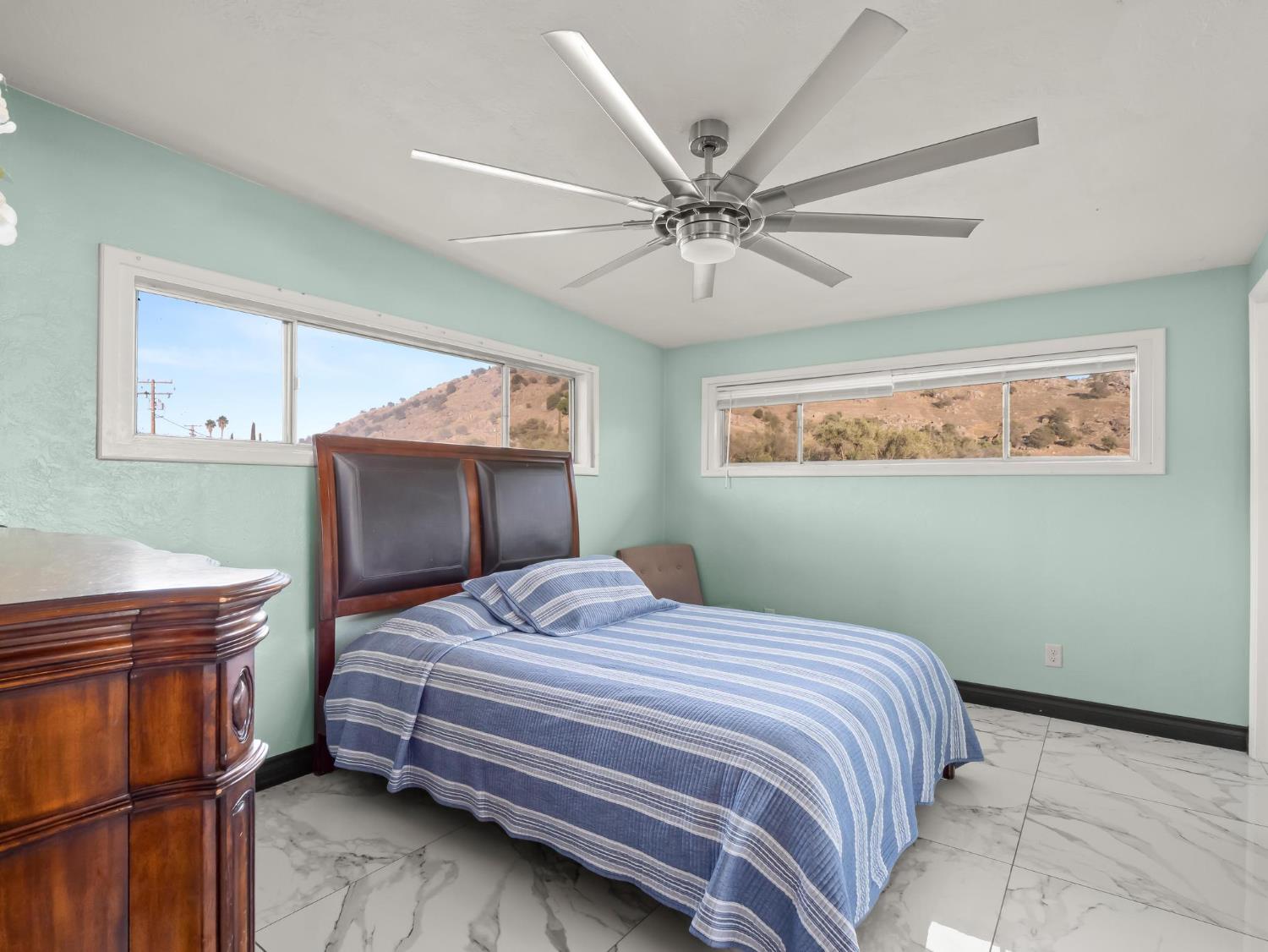 31204 Sierra Drive Exeter, CA 93221 - Photo 40 of 76 a bedroom with a bed and a chandelier