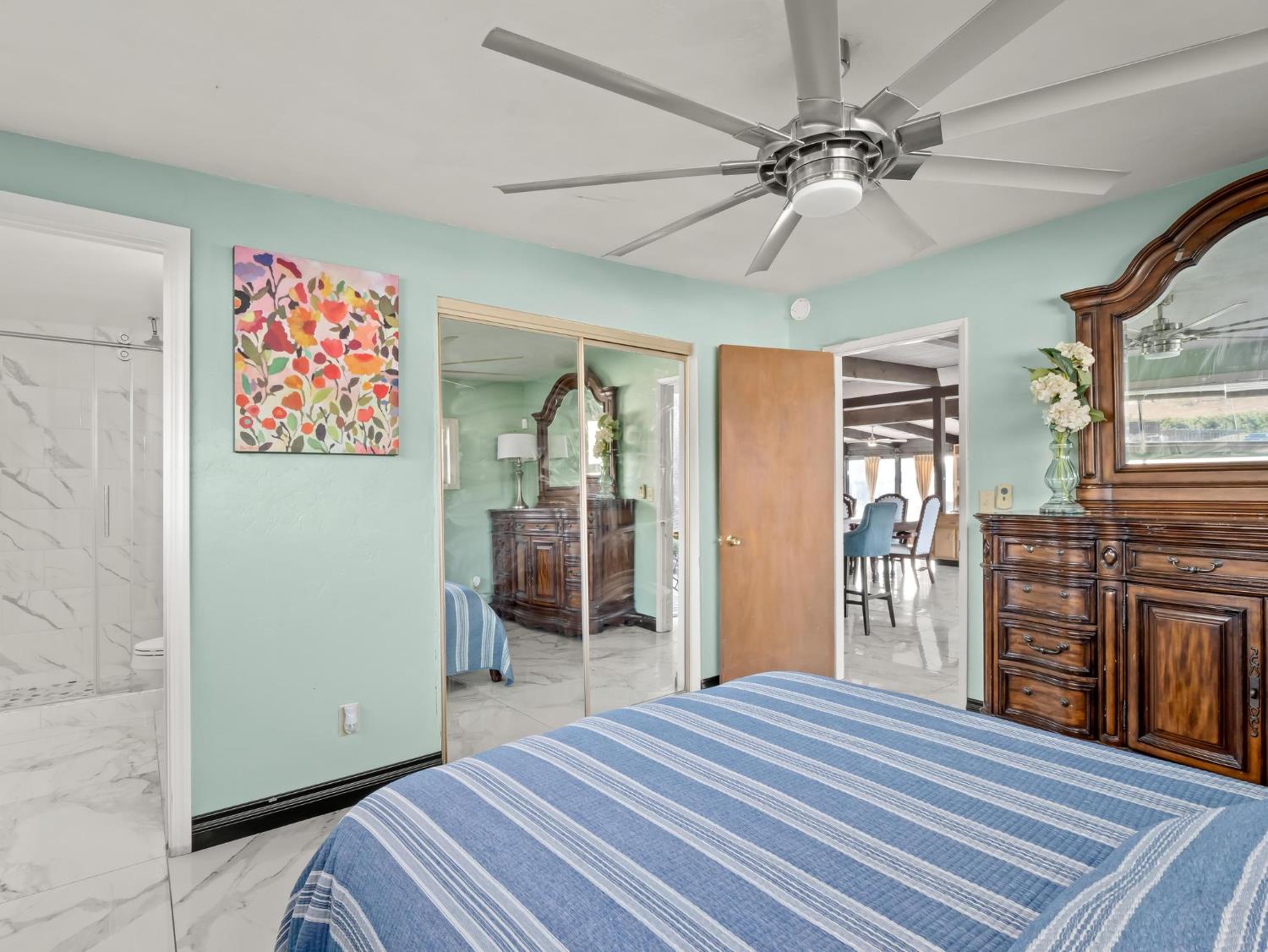 31204 Sierra Drive Exeter, CA 93221 - Photo 42 of 76 a bedroom with a bed and a chandelier