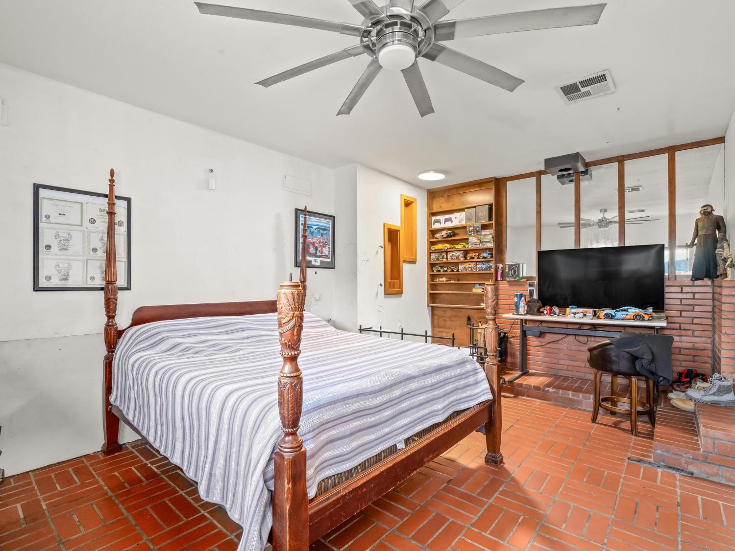 31204 Sierra Drive Exeter, CA 93221 - Photo 43 of 76 a bedroom with a bed and a flat screen tv