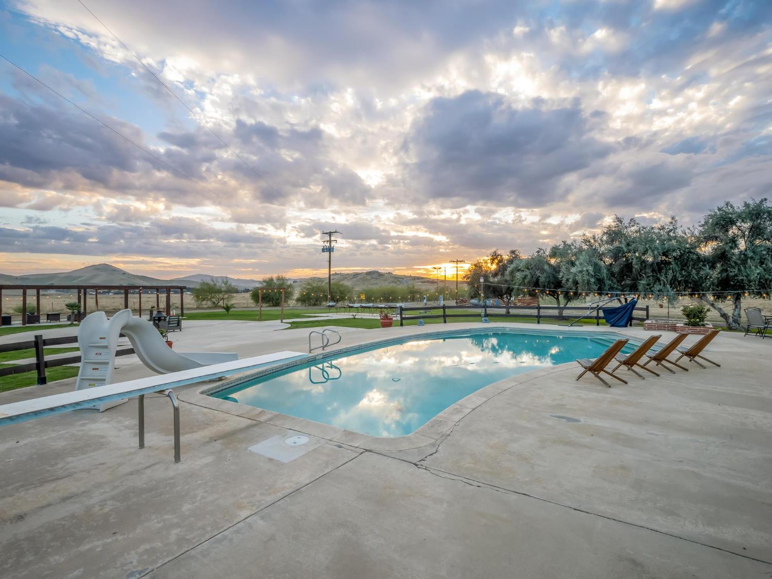 31204 Sierra Drive Exeter, CA 93221 - Photo 64 of 76 a view of a swimming pool with a yard and sitting area