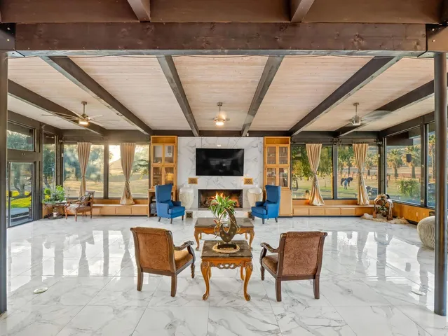 a dining hall with stainless steel appliances kitchen island granite countertop furniture and a kitchen view