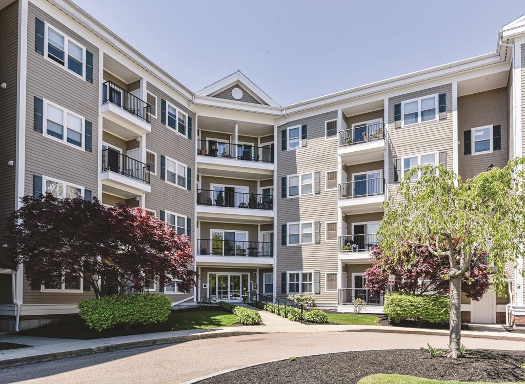 989 East Street, Unit 402 Dedham, MA 02026 - Photo 1 of 28 a front view of a building with street view