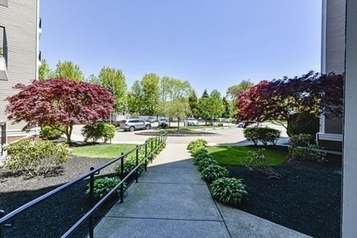 989 East Street, Unit 402 Dedham, MA 02026 - Photo 2 of 28 a view of a lake with a garden