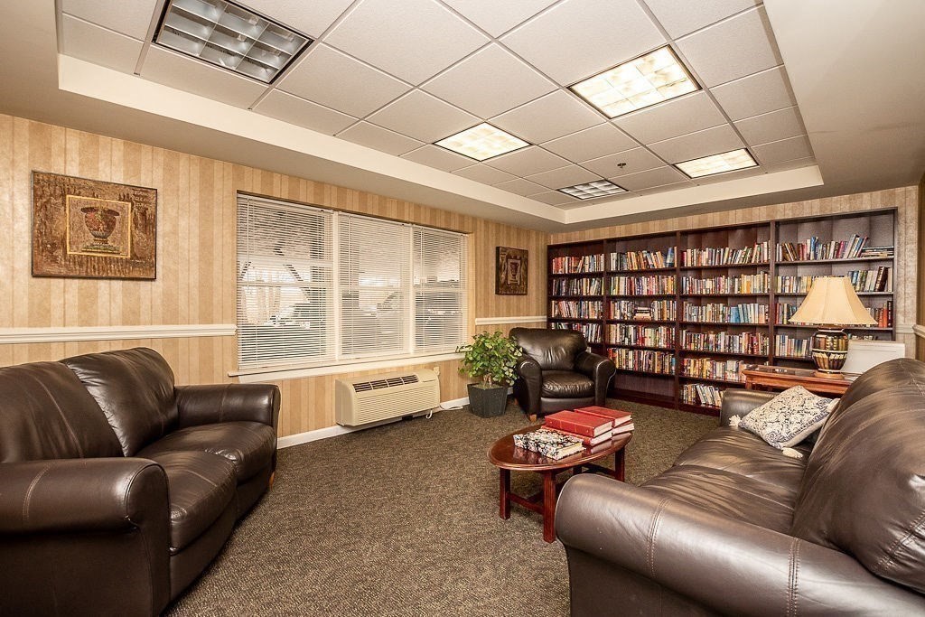 989 East Street, Unit 402 Dedham, MA 02026 - Photo 25 of 28 a living room with furniture and a large window