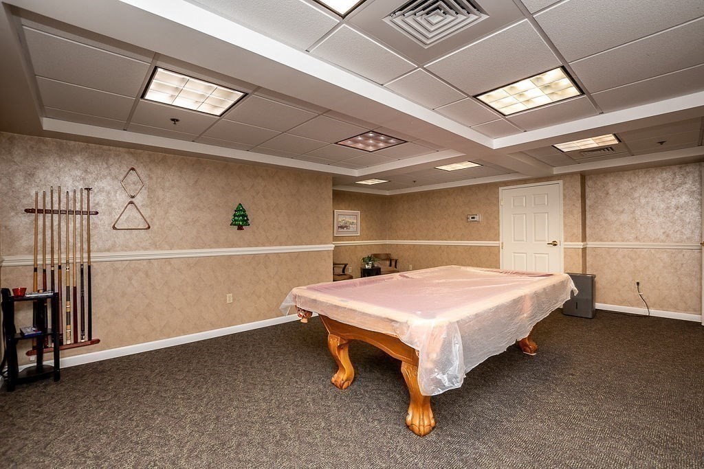 989 East Street, Unit 402 Dedham, MA 02026 - Photo 27 of 28 a spacious bedroom with a bed and a table