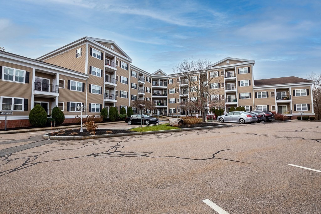 989 East Street, Unit 402 Dedham, MA 02026 - Photo 3 of 28 a front view of a building with street view