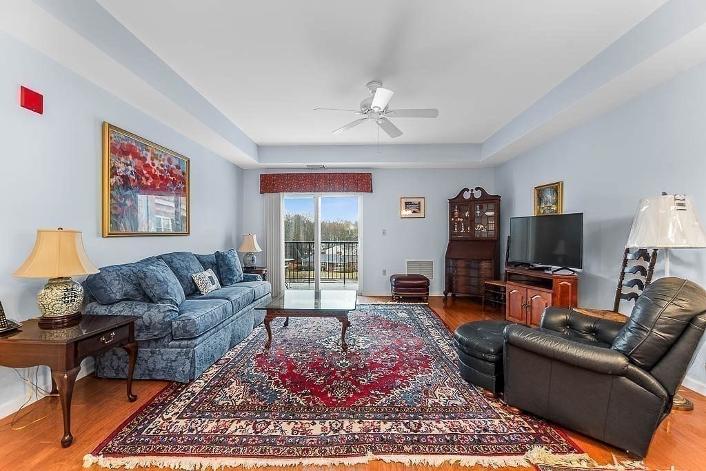 989 East Street, Unit 402 Dedham, MA 02026 - Photo 7 of 28 a living room with furniture and a flat screen tv