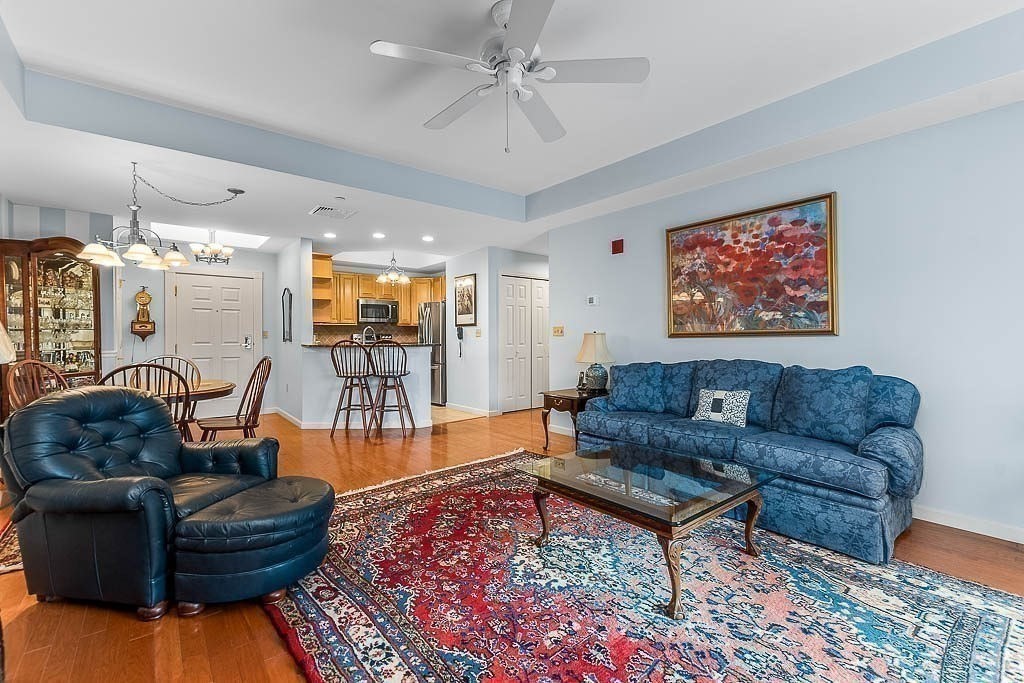 989 East Street, Unit 402 Dedham, MA 02026 - Photo 9 of 28 a living room with furniture and wooden floor