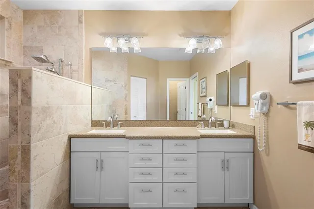 a bathroom with a double vanity sink and mirror