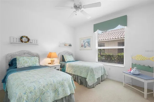 a bedroom with two beds and a table