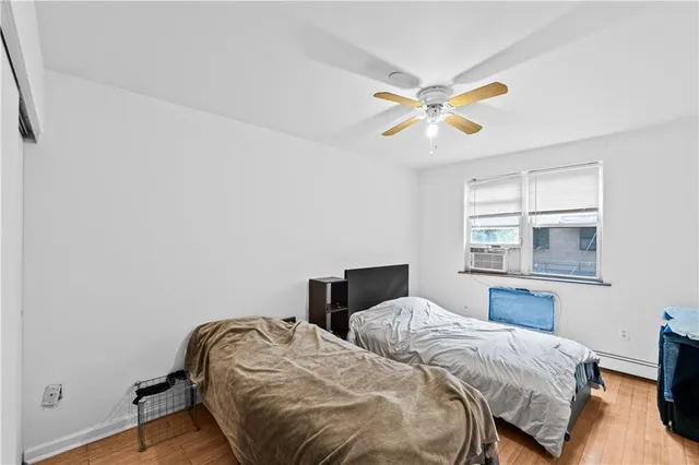 a bedroom with two beds and a window