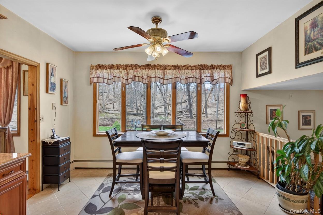 449 West Mombasha Road Monroe, NY 10950 - Photo 30 of 39 a dining room with furniture a chandelier and a rug
