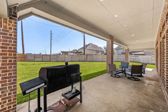 a view of a patio with a table and chairs