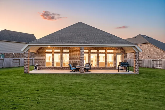 a house view with a sitting space and garden