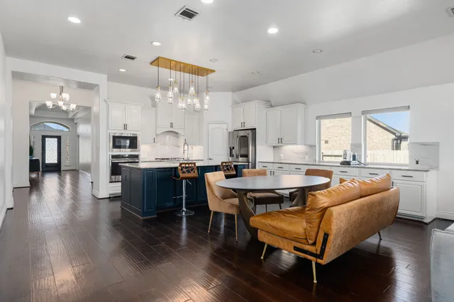 a large kitchen with a table and chairs