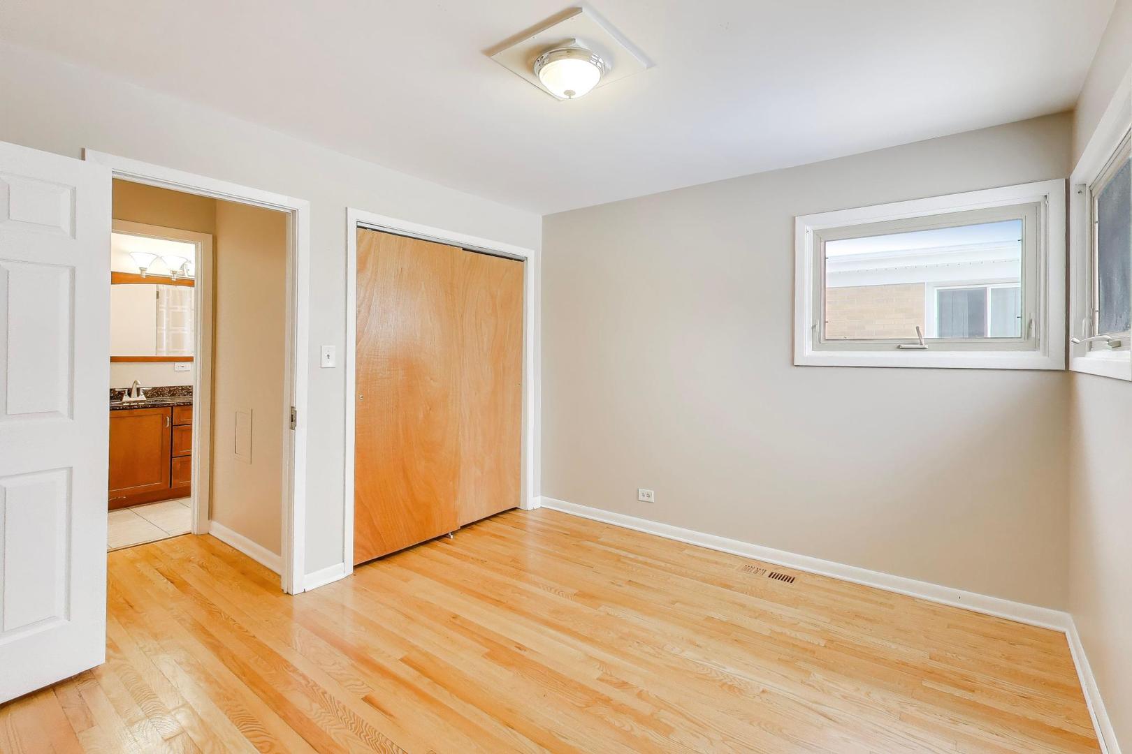 9416 Oliphant Avenue Morton Grove, IL 60053 - Photo 15 of 27 a view of an empty room with wooden floor and a window