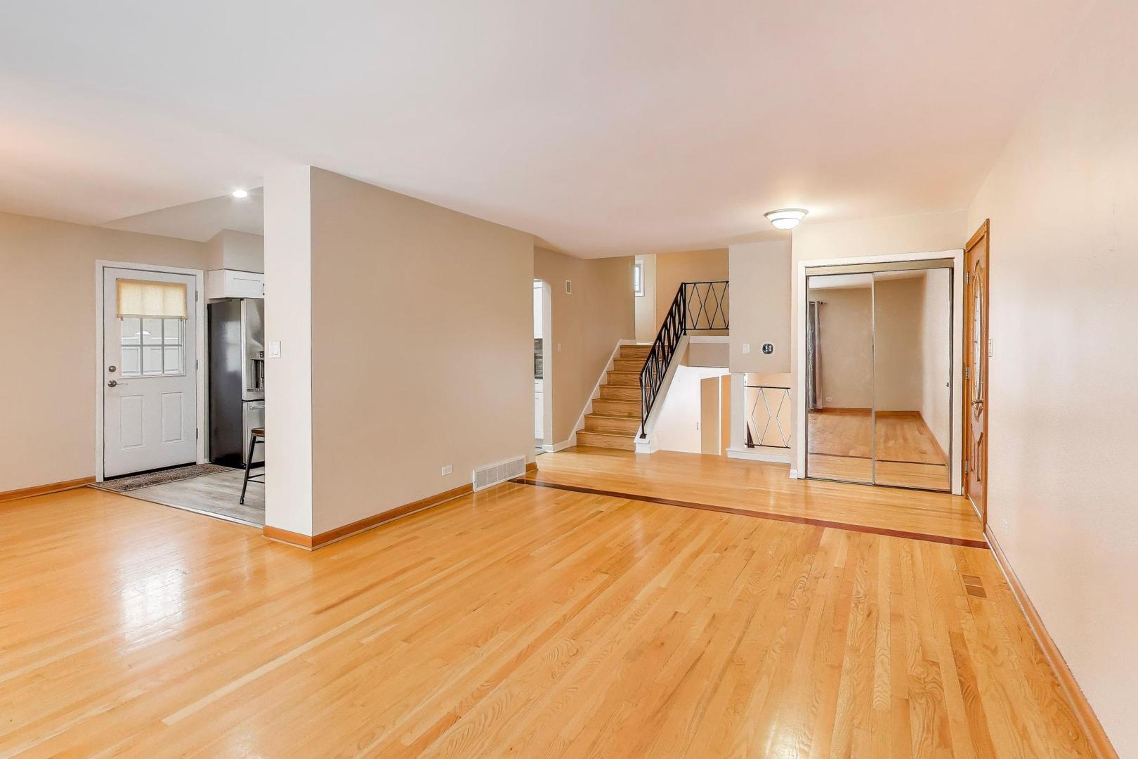 9416 Oliphant Avenue Morton Grove, IL 60053 - Photo 8 of 27 a view of a room with wooden floor and white doors