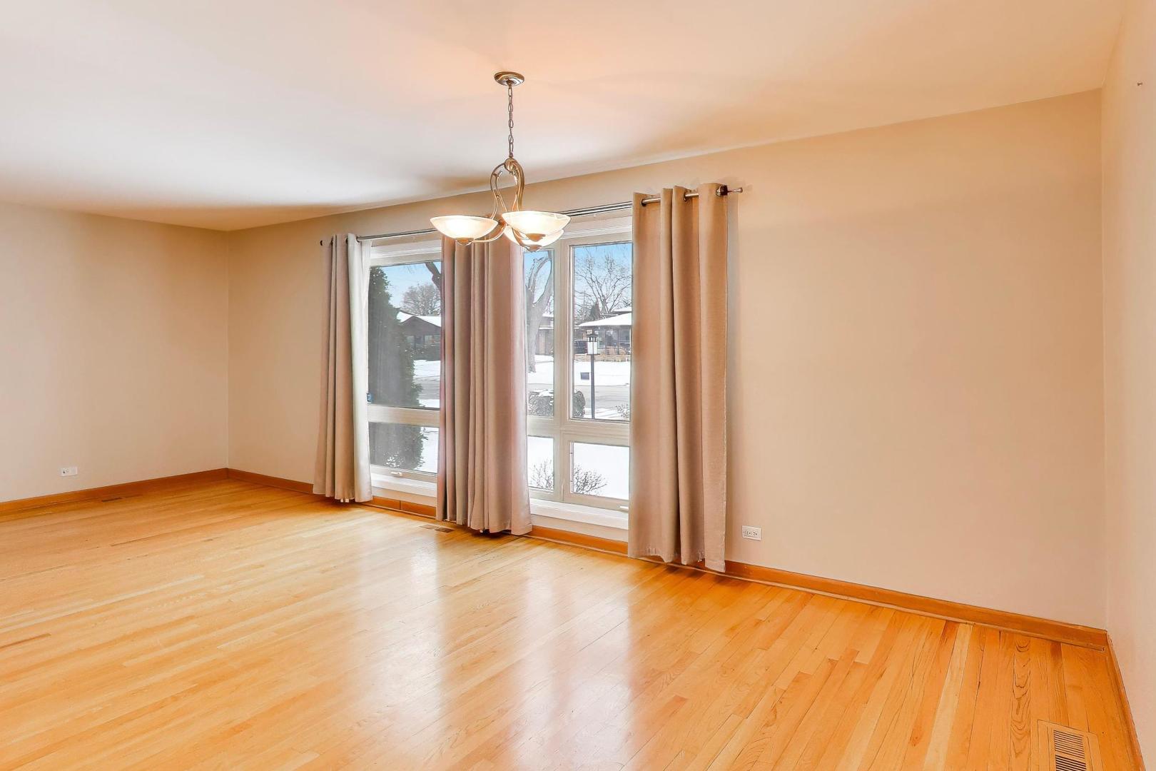 9416 Oliphant Avenue Morton Grove, IL 60053 - Photo 9 of 27 a view of empty room with wooden floor and fan