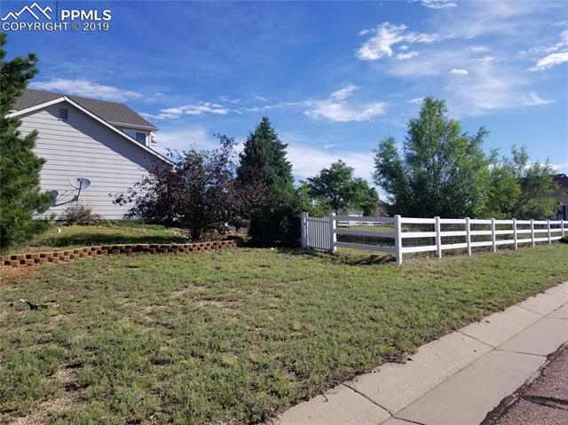 8707 Del Rio Road Peyton, CO 80831 - Photo 15 of 15 Side yard, looking towards backyard w/lots of mature trees.