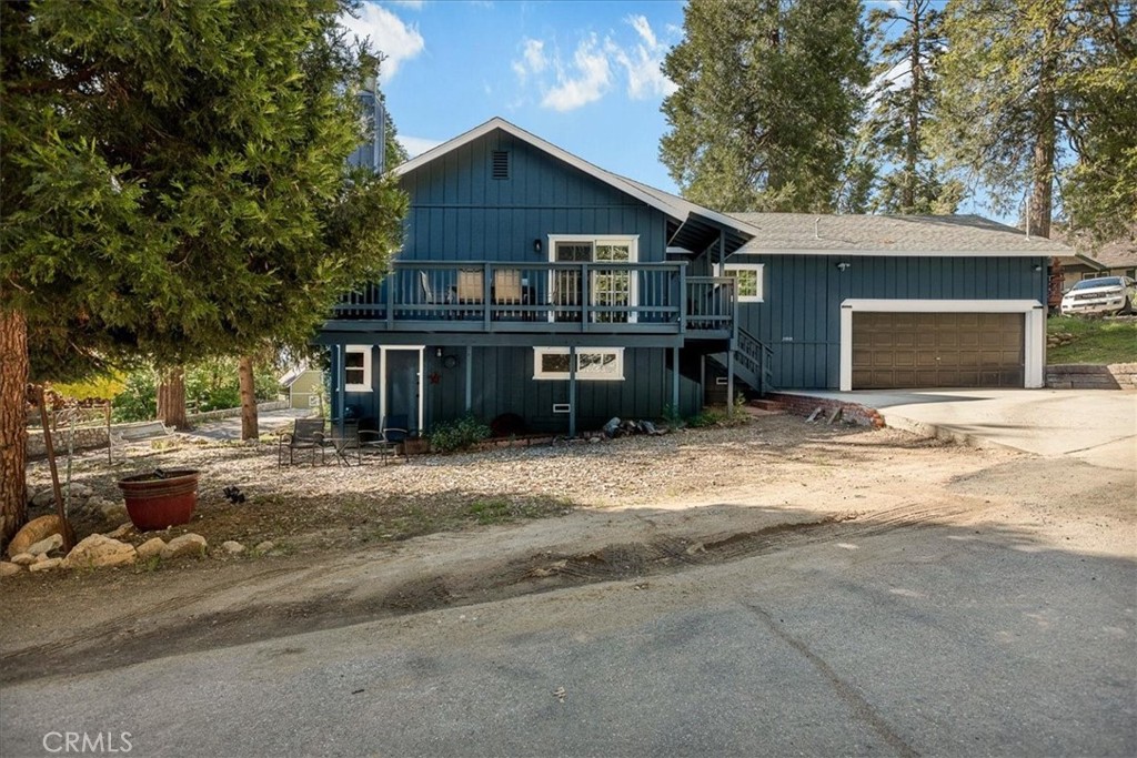 25935 Ranger Drive Twin Peaks, CA 92391 - Photo 1 of 30 a view of a house with a yard and garage