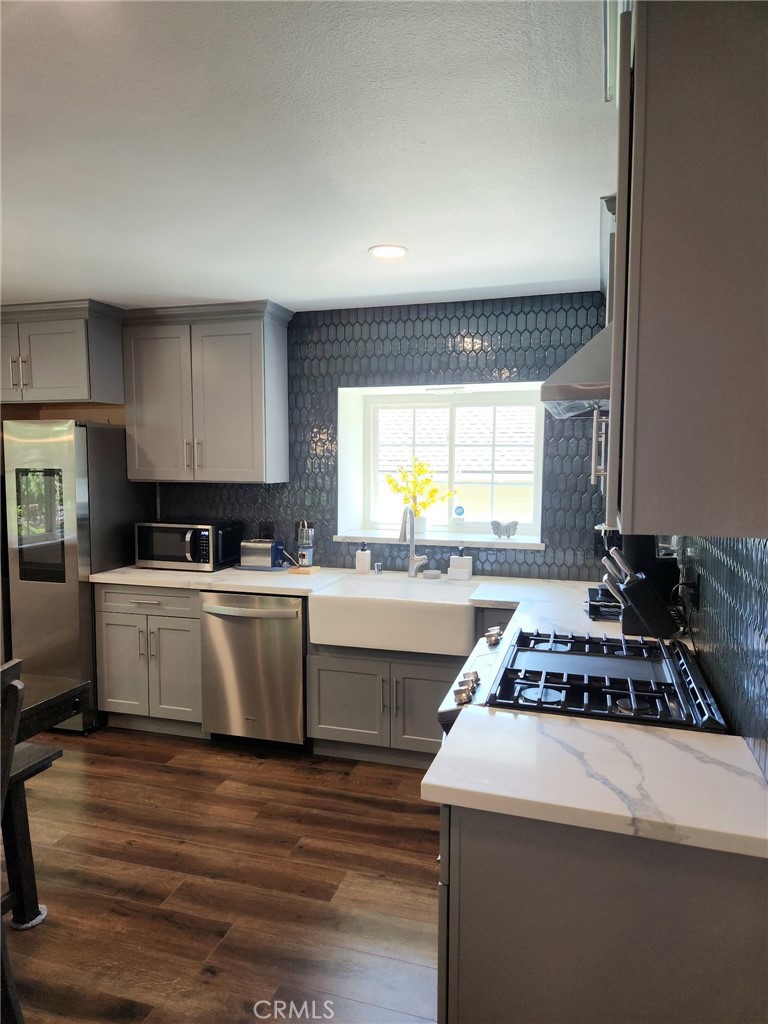 25935 Ranger Drive Twin Peaks, CA 92391 - Photo 12 of 30 a kitchen with a stove a sink and a window