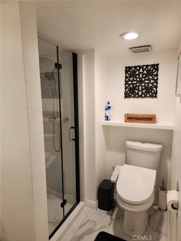 25935 Ranger Drive Twin Peaks, CA 92391 - Photo 23 of 30 a white toilet sitting next to a bathroom sink