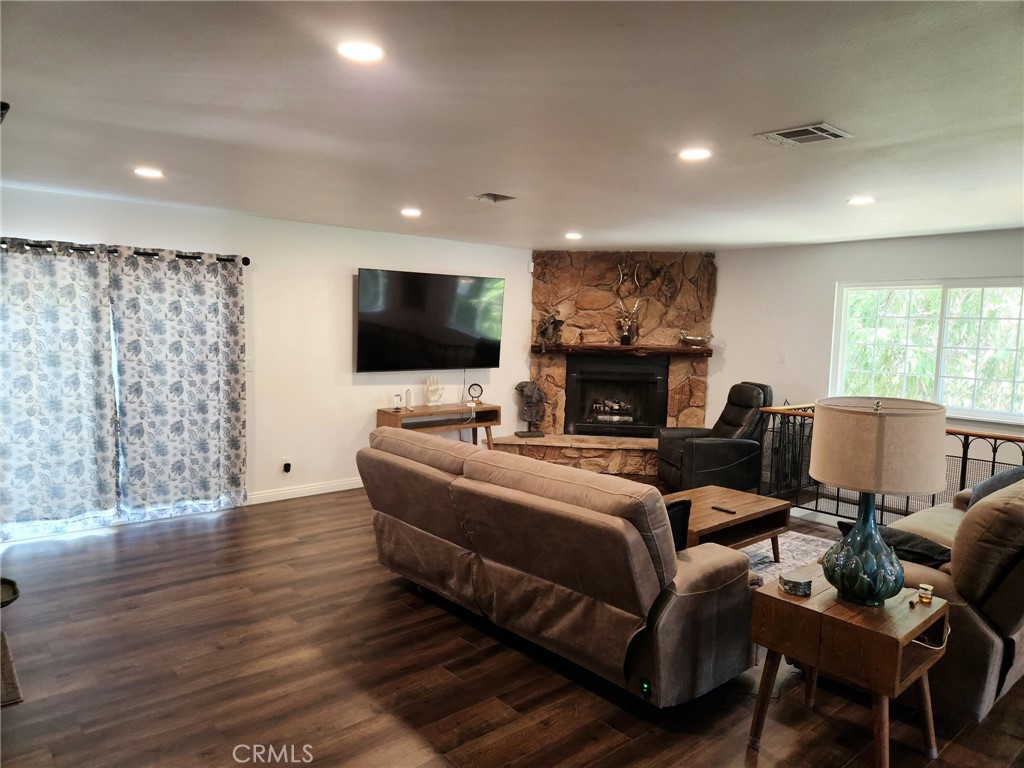 25935 Ranger Drive Twin Peaks, CA 92391 - Photo 6 of 30 a living room with furniture a fireplace and a flat screen tv