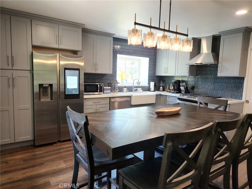 25935 Ranger Drive Twin Peaks, CA 92391 - Photo 8 of 30 a kitchen with a dining table chairs and refrigerator