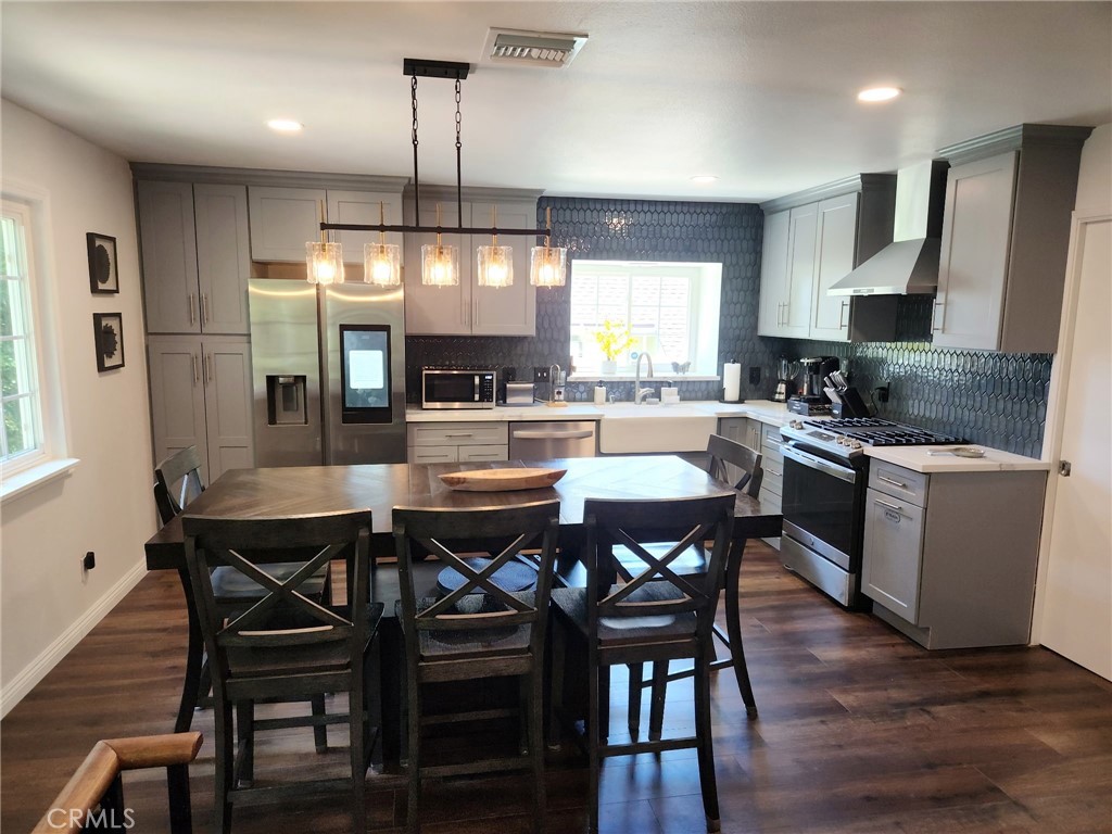 25935 Ranger Drive Twin Peaks, CA 92391 - Photo 9 of 30 a kitchen with a dining table chairs and wooden floor