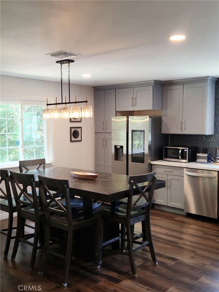25935 Ranger Drive Twin Peaks, CA 92391 - Photo 10 of 30 a kitchen with a table chairs sink and cabinets