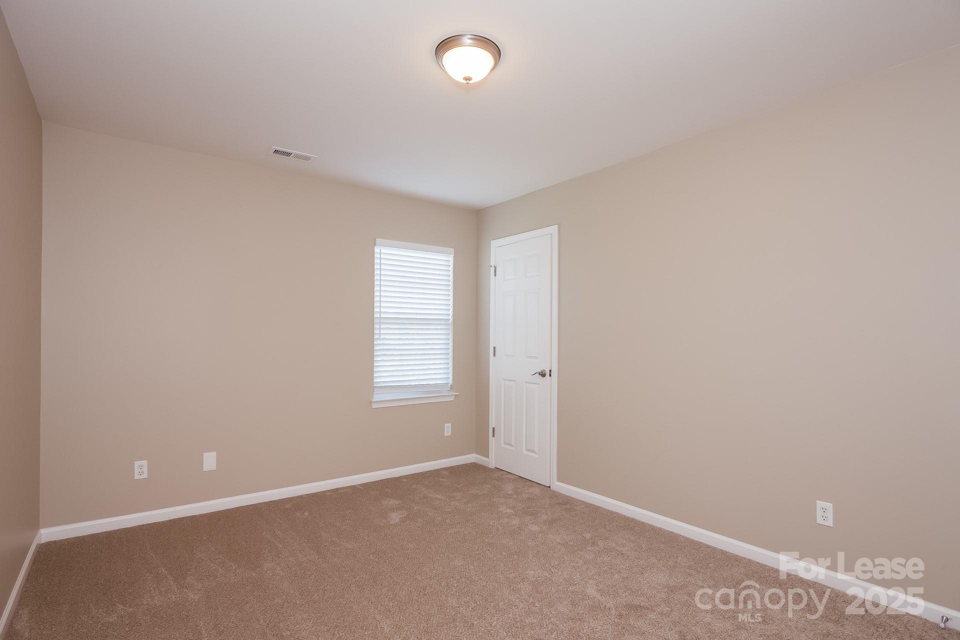 10209 Fairbourne Court Charlotte, NC 28269 - Photo 11 of 15 an empty room with windows and closet