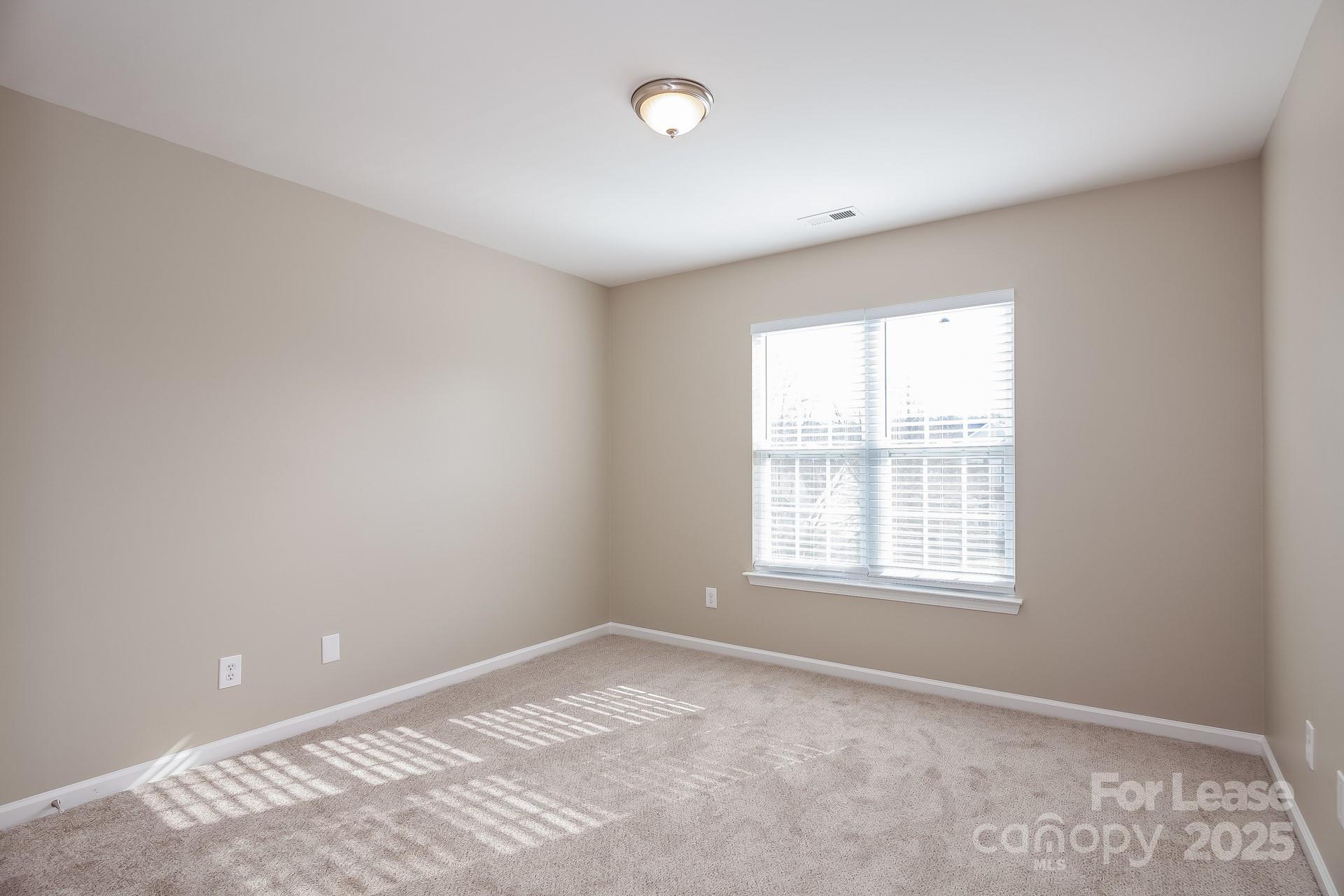10209 Fairbourne Court Charlotte, NC 28269 - Photo 13 of 15 an empty room with a window