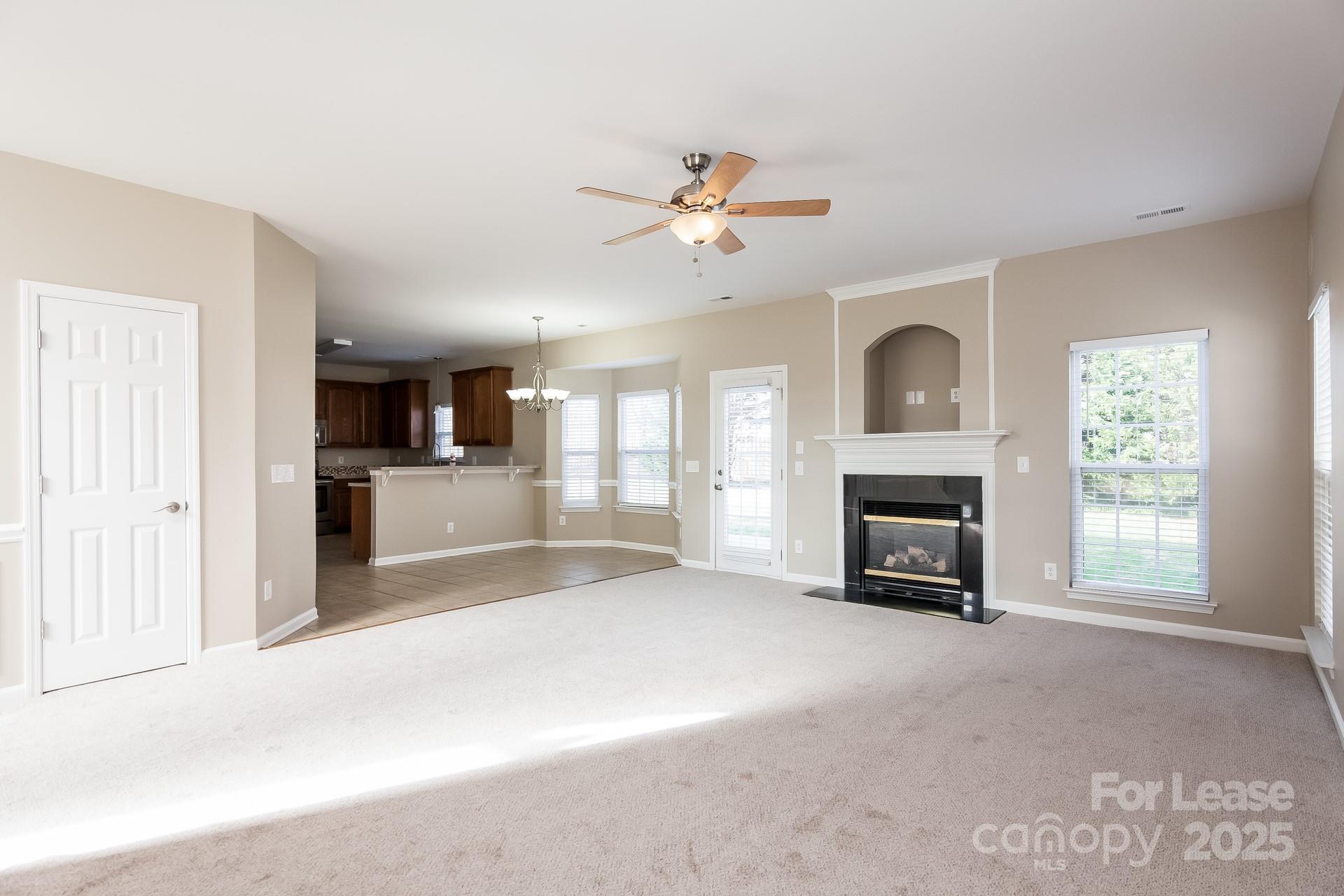 10209 Fairbourne Court Charlotte, NC 28269 - Photo 2 of 15 a view of empty room with a fireplace and window