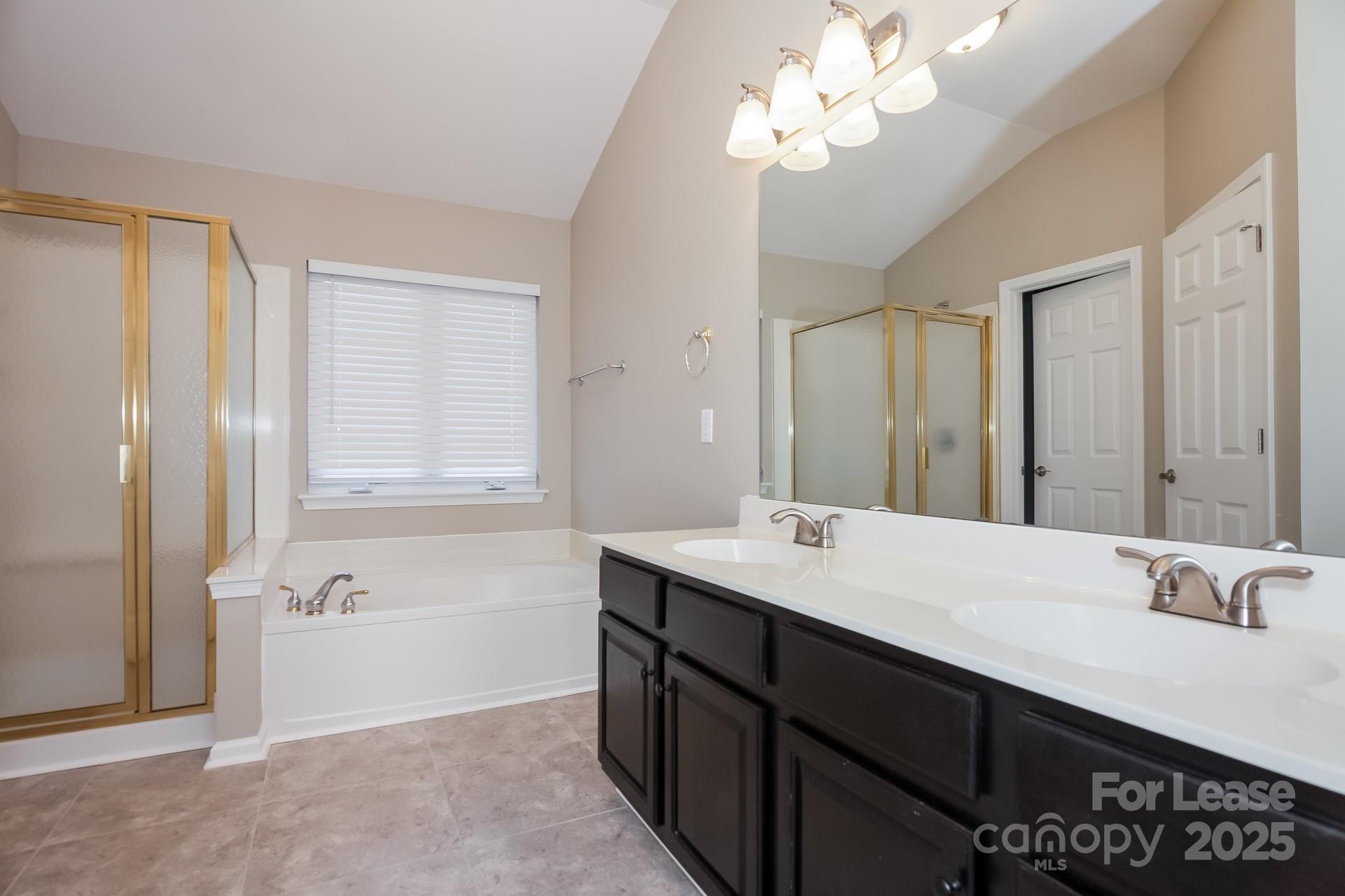 10209 Fairbourne Court Charlotte, NC 28269 - Photo 8 of 15 a bathroom with a sink a mirror and a shower