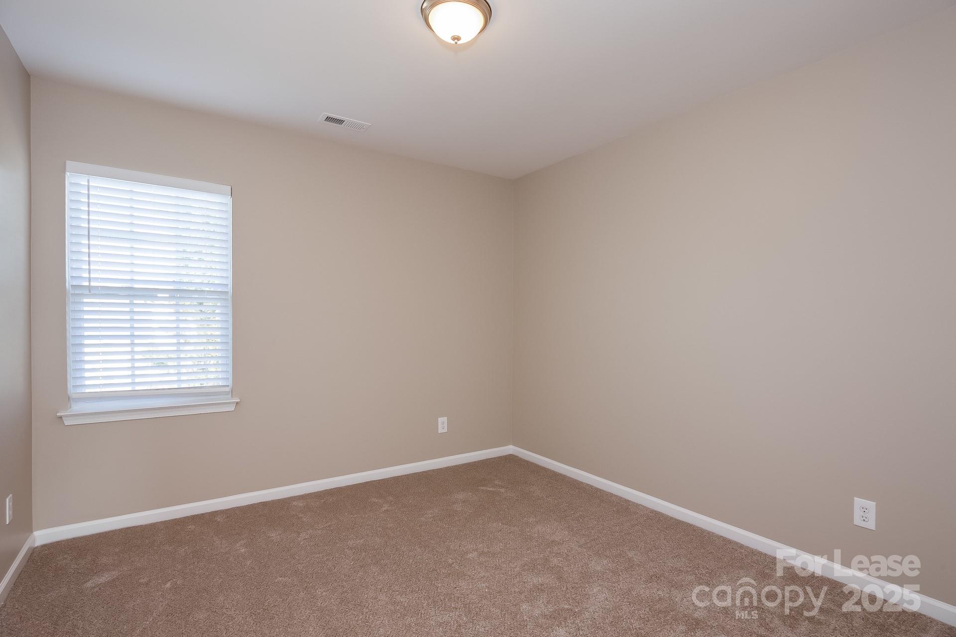 10209 Fairbourne Court Charlotte, NC 28269 - Photo 10 of 15 an empty room with a window