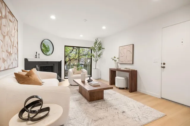 a living room with furniture a fireplace and a table