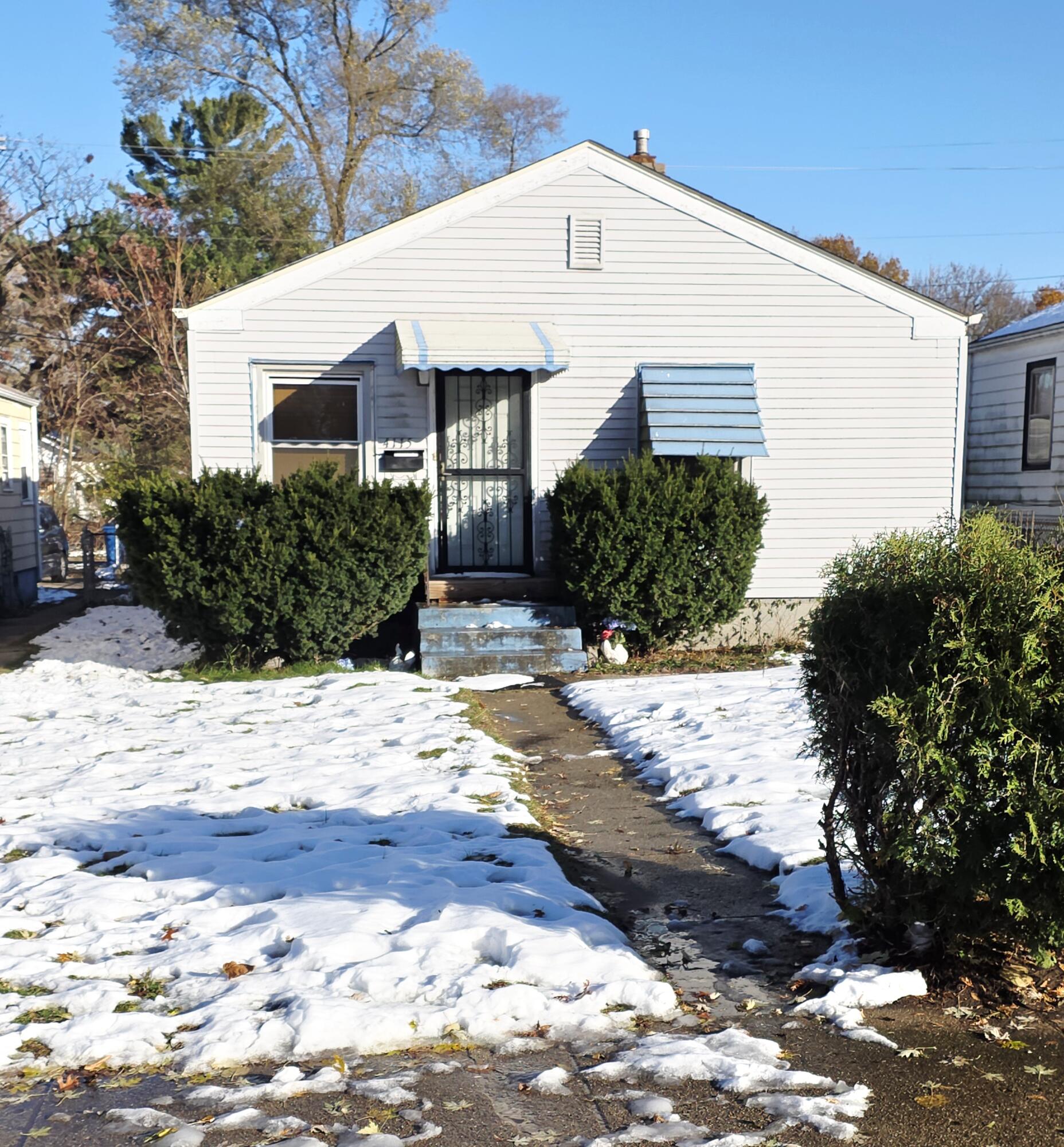 a view of a white house with a yard