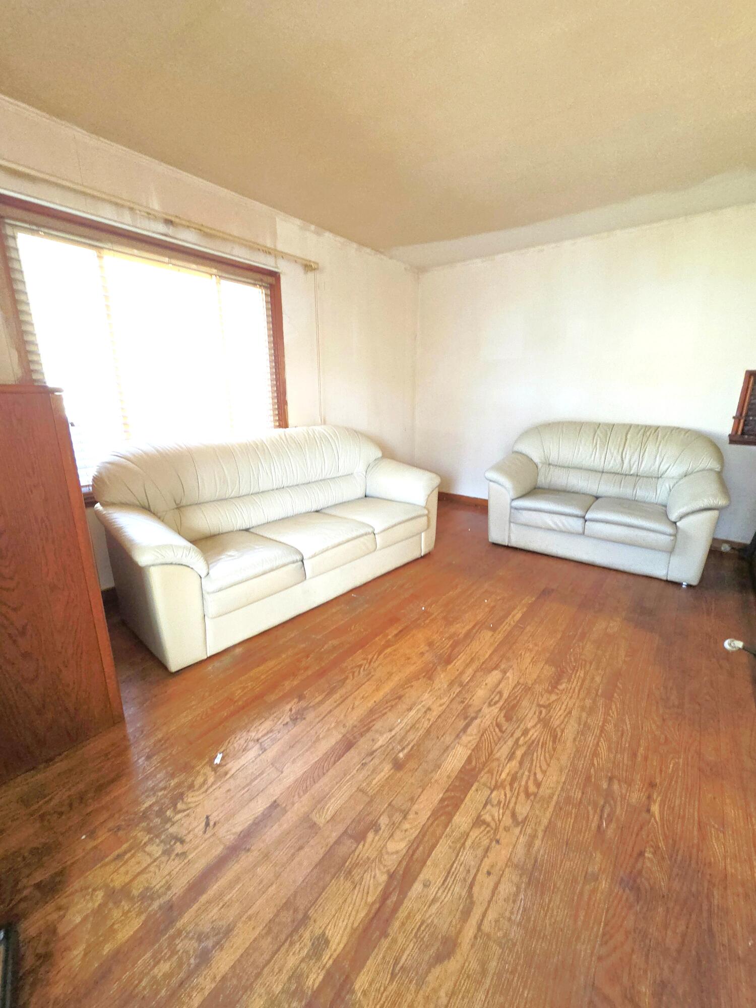 4115 Fillmore Street Gary, IN 46408 - Photo 2 of 16 a spacious bedroom with a bed and a window