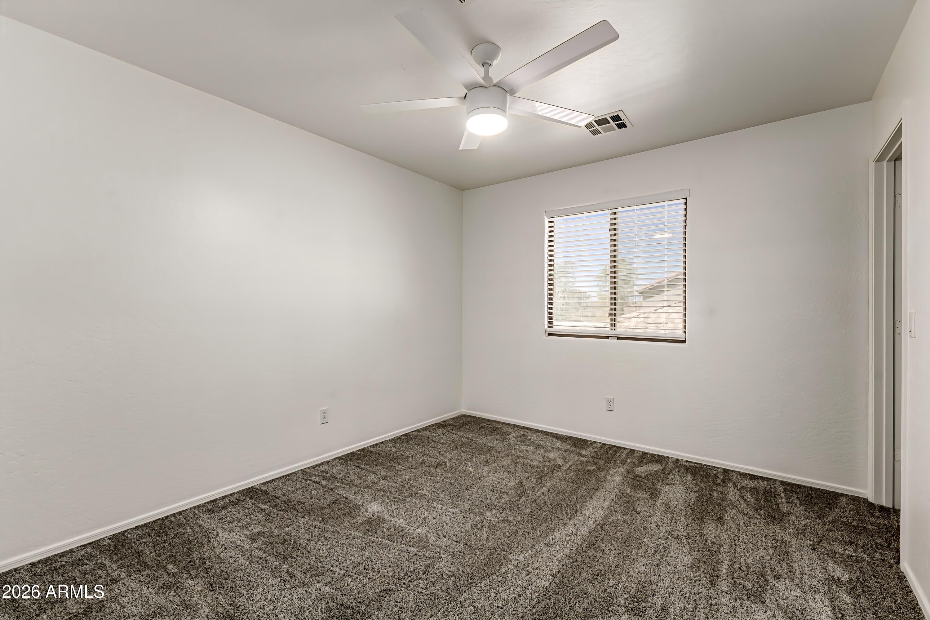 4208 South Sawmill Road Gilbert, AZ 85297 - Photo 25 of 46 an empty room with a window and ceiling fan