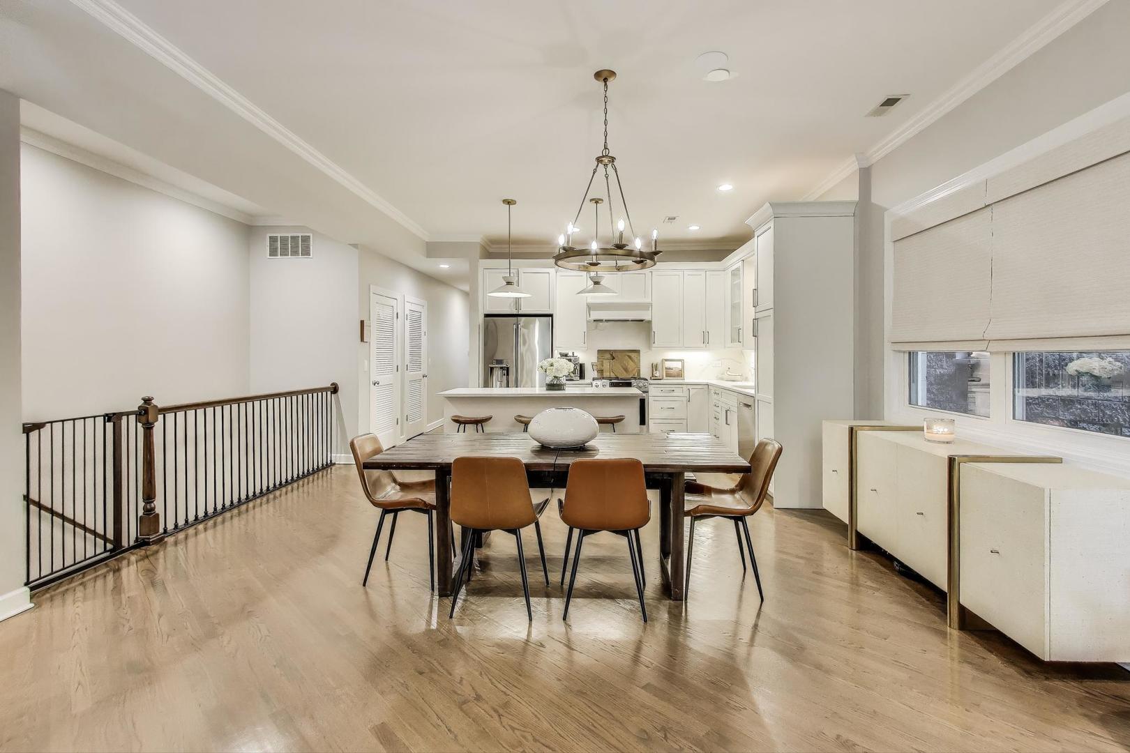 1533 North Cleveland Avenue, Unit 1S Chicago, IL 60610 - Photo 11 of 36 a dining room with chandelier and wooden floor