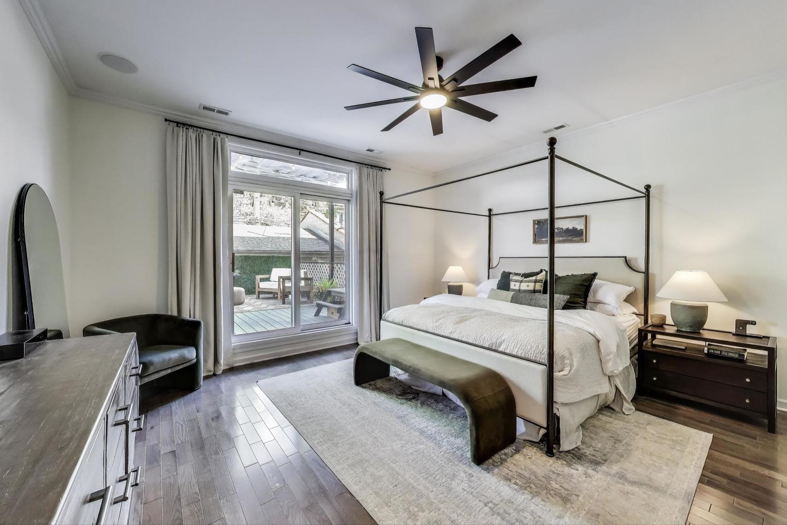 1533 North Cleveland Avenue, Unit 1S Chicago, IL 60610 - Photo 13 of 36 a bedroom with a bed a large window with wooden floor