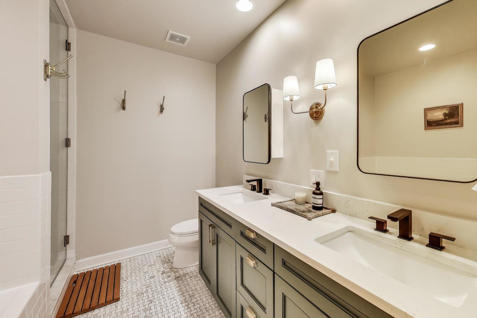 1533 North Cleveland Avenue, Unit 1S Chicago, IL 60610 - Photo 16 of 36 a bathroom with a sink a toilet and a mirror