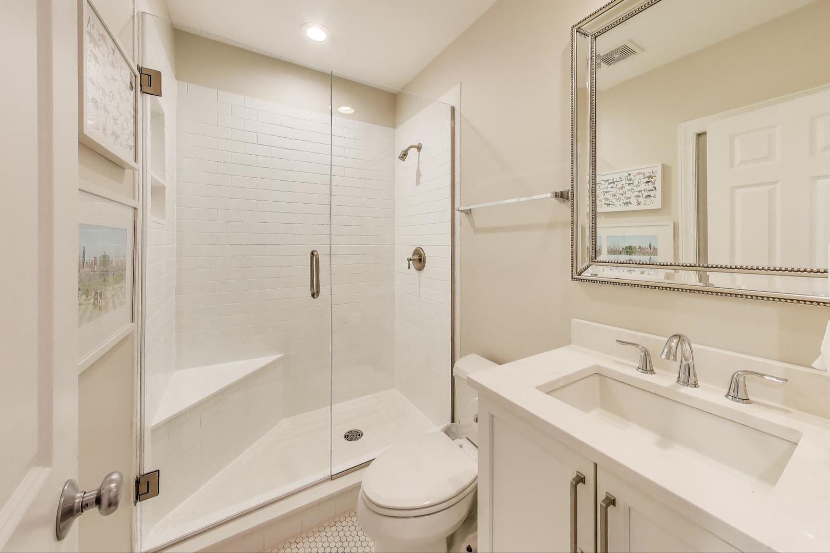 1533 North Cleveland Avenue, Unit 1S Chicago, IL 60610 - Photo 25 of 36 a bathroom with a sink toilet and shower