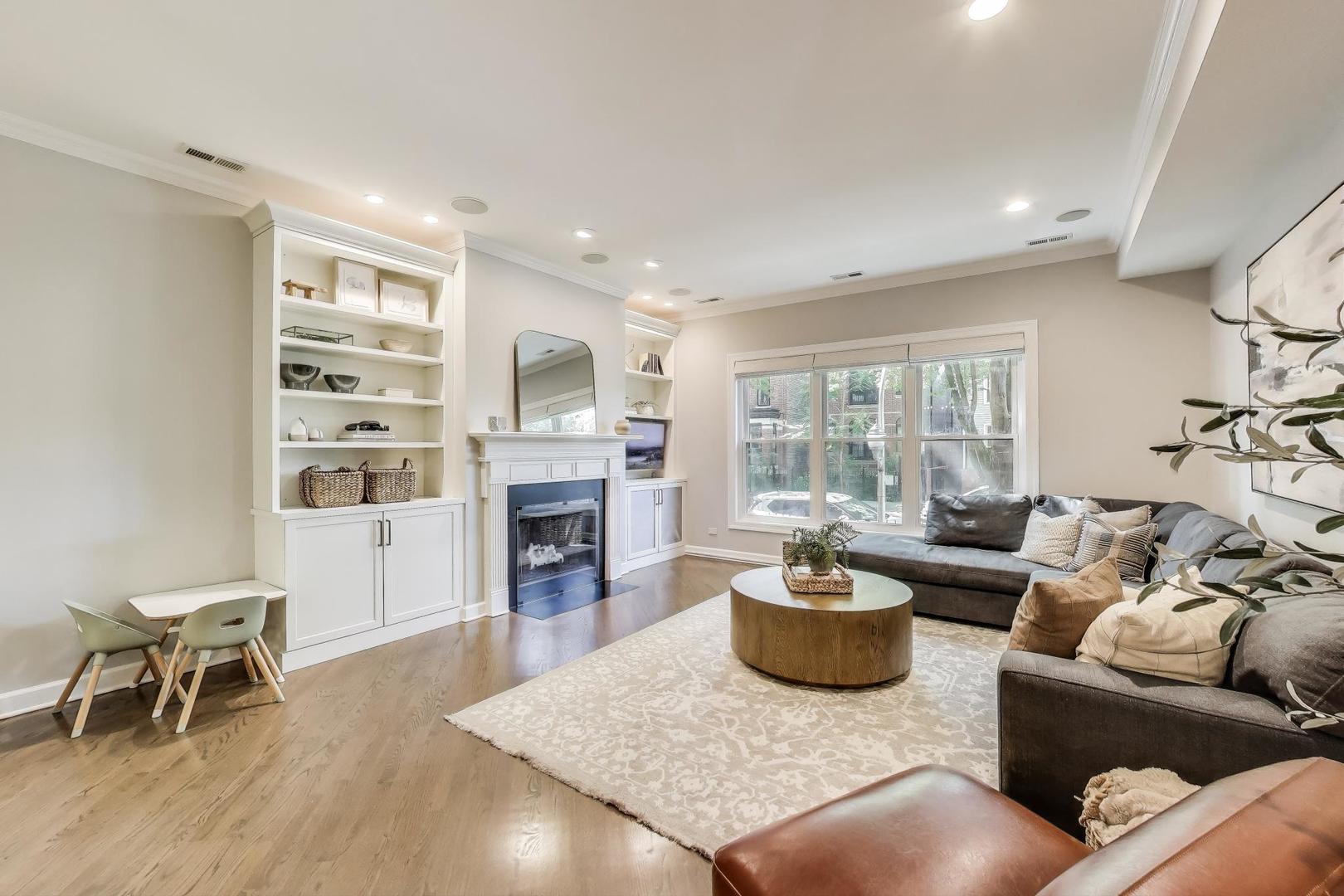 1533 North Cleveland Avenue, Unit 1S Chicago, IL 60610 - Photo 5 of 36 a living room with furniture a fireplace and a flat screen tv