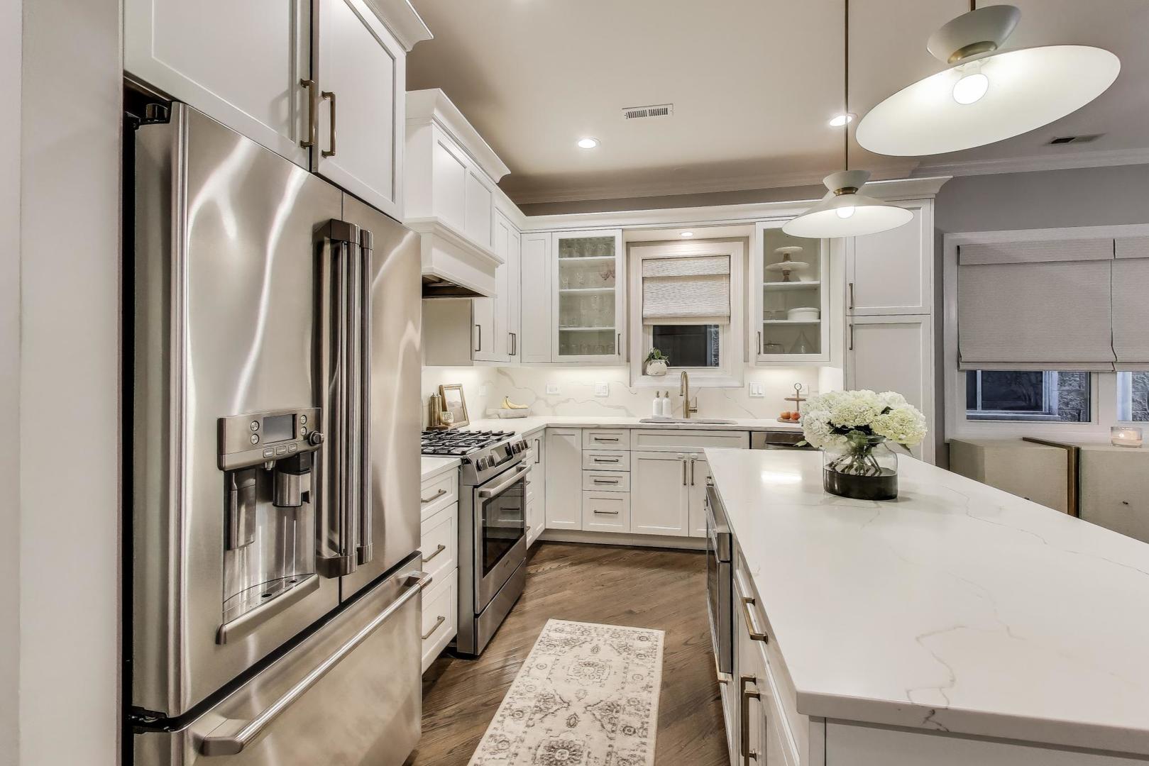 1533 North Cleveland Avenue, Unit 1S Chicago, IL 60610 - Photo 10 of 36 a kitchen with stainless steel appliances a refrigerator a stove and white cabinets